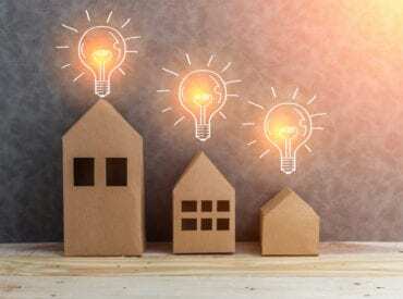 3 wooden homes with light bulbs