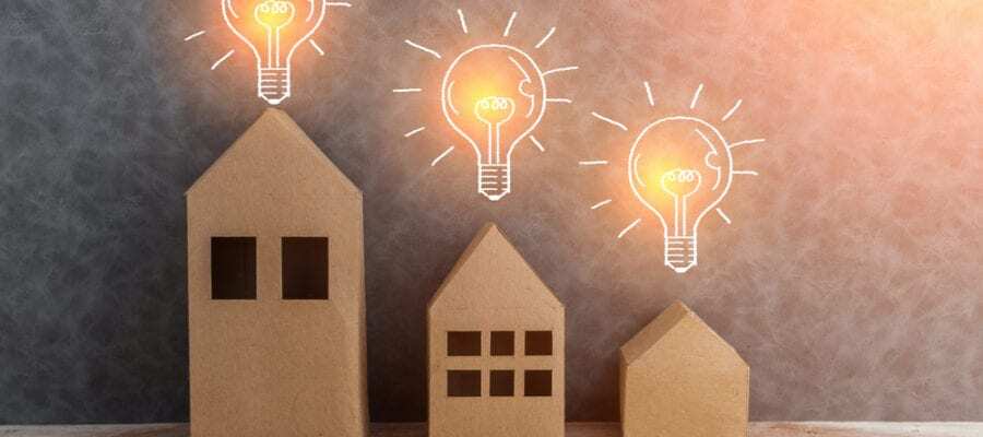 3 wooden homes with light bulbs